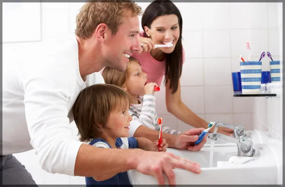 family brushing their teeth together